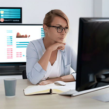 Woman in front of computer authoring content.